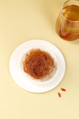 Cornhusk Tea Brewing Ingredients with Herbal Infusion Glass on Neutral Background