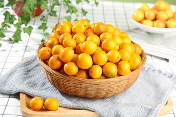Fresh Sweet Kumquats in Wicker Basket - Smooth Skinned Citrus Fruits Ready to Share