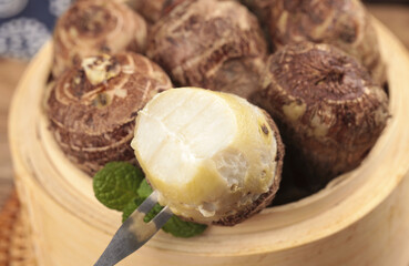 Fresh Taro Root Bulbs in Wooden Bowl - Traditional Asian Cooking Ingredient from Shandong China