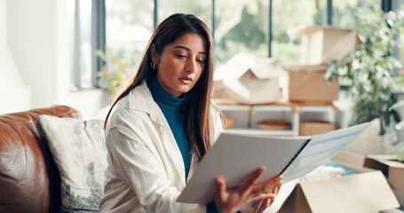 New home, reading and woman on sofa, relax and knowledge with rental agreement. Apartment, property owner and person on couch, lease and tenant with mortgage contract, relocation and information