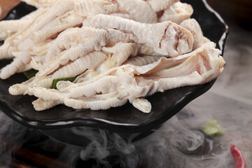 Fresh Raw Chicken Feet with Claws on Grill Pan for Asian Cooking