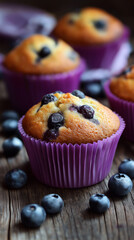 Fresh homemade blueberry muffins on wooden board with berries. 
