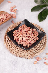 Raw Peanuts in Black Bowl on Woven Mat - Healthy Snack Ingredient for Traditional Asian Cooking