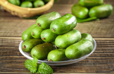 Fresh Mini Kiwi Heart-Shaped Green Fruits in Bowl on Wooden Table with Soft Natural Display