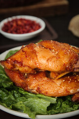 Szechuan Spiced Cold Rabbit Leg Traditional Chinese Cuisine Dish with Fresh Lettuce and Chili Oil