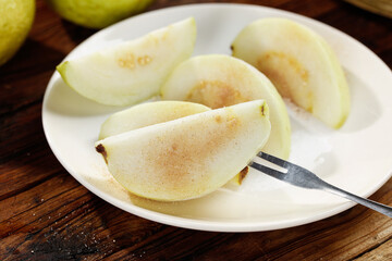 Fresh White Guava Slices with Creamy Flesh and Heart-Shaped Seeds on White Plate