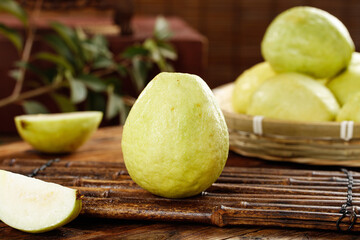 Fresh Tropical Guava Fruits on Rustic Wood Background with Sliced Pieces