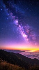 Fototapeta premium Milky Way above mountain range at dawn