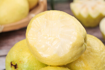 Fresh Guava Fruit Sliced Open Showing White Creamy Flesh and Heart Pattern on Wooden Board