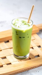 Iced matcha latte in glass on tray