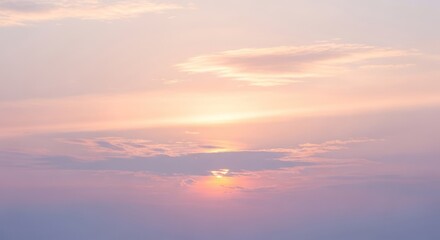 A serene sunset with a soft pink and orange sky, scattered clouds, and a distant sun setting behind a mountain range.