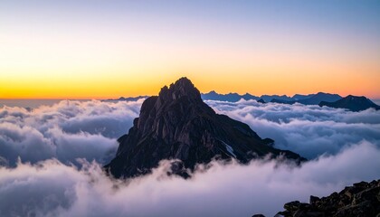 Majestic mountain peak rising above a sea of clouds at sunrise