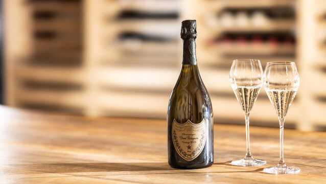 Paris, France - September. 13, 2025: A bottle of one of the most famous champagnes, Dom P&eacute;rignon, vintage 2013, on a table in a wine shop along with two glasses