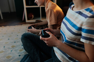 Two gen z teenagers playing video games at home