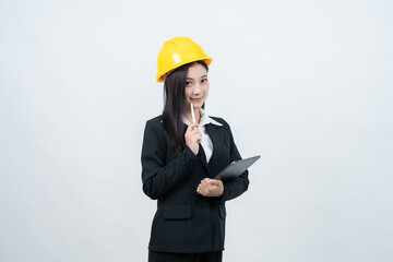 The portrait of an Asian female engineer in a suit and helmet, captured in a white background studio, highlights her essential expertise and responsibility that influence the entire industry.