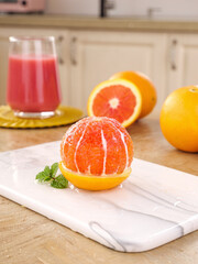 Fresh Blood Orange Segments with Citrus Juice on Marble Cutting Board Kitchen Display