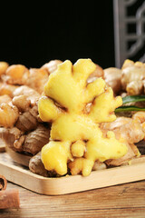 Fresh Ginger Root Sliced Open Showing Yellow Interior on Wooden Cutting Board