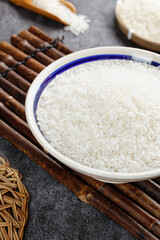Premium White Rice Grains in Bowl on Bamboo Mat - Traditional Asian Cooking Ingredients