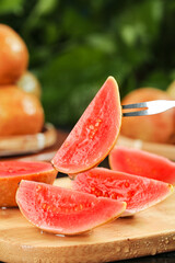 Fresh Red Guava Slices on Wooden Board - Tropical Fruit Ready to Eat