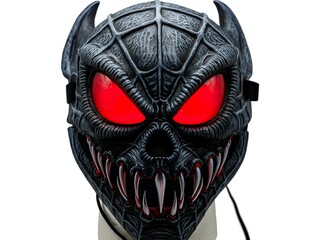 Terrifying demon monster mask with glowing red eyes and a spiderweb pattern. Isolated horror costume accessory on a white background for Halloween