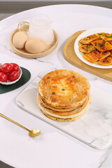 Traditional Scallion Pancakes with Fresh Ingredients on Marble Kitchen Counter