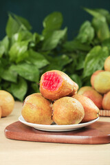 Fresh Red Heart Guava Fruits with Soft Creamy Flesh on Wooden Board