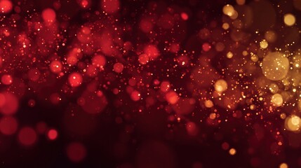 Abstract bokeh lights display a warm blend of red and golden hues on dark background