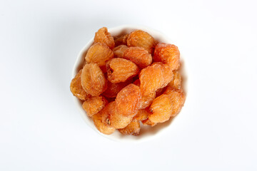Dried Longan Fruit in White Bowl on White Background - Asian Tropical Fruit Snack