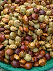 Close-up view of a large pile of various-colored seeds, likely a type of legume or fruit.