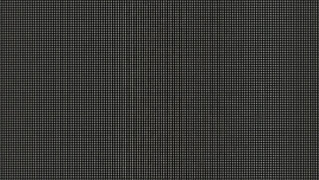A consistent, repeating grid pattern dominates this dark gray surface.