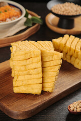 Dried Tofu Slices on Wooden Board - Traditional Asian Soy Product for Cooking and Skewering