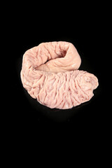 Naklejka premium Fresh Raw Pork Sausage Casing on Black Background for Butcher Shop Display