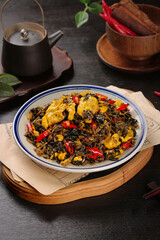Traditional Cantonese Homemade Dried Vegetable Dish with Red Peppers and Tea Service on Dark Wood Table