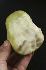 Fresh Guava Fruit Cut in Half Showing White Creamy Flesh and Soft Texture on Dark Background