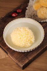 Traditional Chinese Glutinous Rice Dessert with Ginkgo Nuts and Red Dates on Wooden Serving Tray