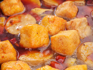 Hot Pot Fried Tofu Cubes Bubbling in Spicy Broth for Shabu Shabu Asian Dining