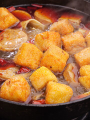 Hot Pot Shabu Shabu with Fried Tofu and Vegetables in Spicy Broth