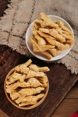 Traditional Dried Bean Curd Knots in Bowls - Handmade Asian Food Ingredient on Wooden Table
