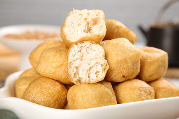 Golden Fried Tofu Puffs in Bowl - Traditional Asian Vegetarian Protein Food Ingredient