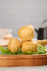 Golden Fried Tofu Puffs on Lettuce Leaves - Asian Vegetarian Cuisine Ingredient
