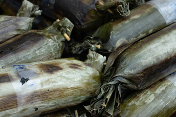 The grilled rice is wrapped in banana leaf stalks.