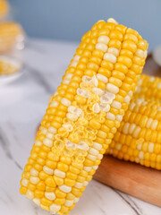 Fresh Sweet Corn Cob with Bite Marks on Wooden Board - Golden Yellow Kernels Natural Food Photography