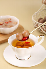 Herbal Wolfberry Longan Tea with Dried Fruits in White Cup - Traditional Winter Wellness Drink