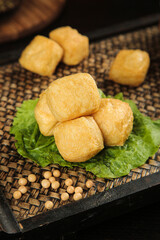 Golden Fried Tofu Puffs on Lettuce Leaves with Soybeans - Asian Vegetarian Cuisine