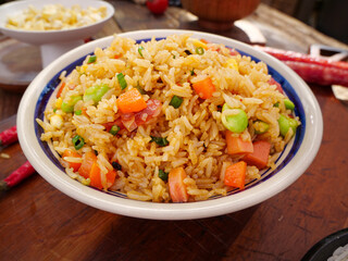 Traditional Fried Rice Casserole with Preserved Meat and Vegetables in Ceramic Bowl