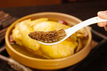 Nourishing Chinese Chicken Yam Mushroom Soup with Clear Broth in Traditional Ceramic Bowl