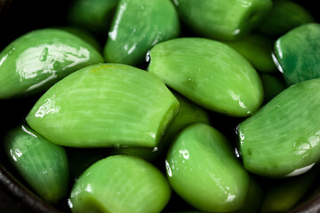Fresh Pickled Garlic Cloves in Bowl - Green Jade Colored Preserved Vegetables