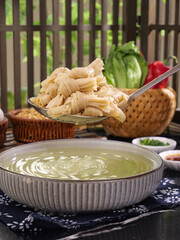 Handmade Roti Knot Pasta with Green Bean Soup Traditional Asian Cooking Kitchen Scene