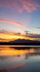 Naklejka premium Sunset over a lake reflecting the colorful sky