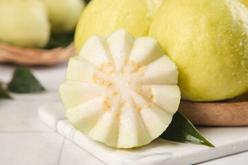 Fresh Sliced Guava Fruit with Cream Flesh Star Pattern on White Marble Background